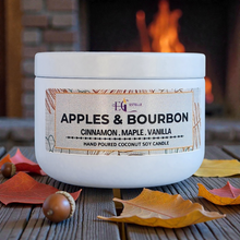 Load image into Gallery viewer, Candle  'Apples &amp; Bourbon' on a wooden surface with autumn leaves and a fireplace in 
the background.
Cinnamon maple vanilla 