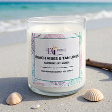 Load image into Gallery viewer, Beach vibes and tan lines Candle with a label on a sandy beach. Raspberry Lily vanilla