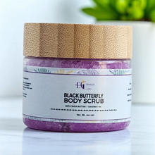 Load image into Gallery viewer, Jar of Black Butterfly Body Scrub with a purple label on a white surface. Our sugar scrubs are formulated with luxurious ingredients, The sugar granules delicately exfoliate, while the shea butter, sunflower oil, and apricot kernel oil work together to hydrate and moisturize

