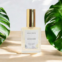 Load image into Gallery viewer, This image features an elegantly designed bottle of Mens cologne, with gold caps. The bottles are labeled "Black Butterfly" and are presented on a wooden surface with large green leaves in the background, enhancing the natural and sophisticated appeal of the products.