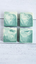 Load image into Gallery viewer, Four green and white marbled soap bars on a light wooden surface.Indulge in our  handmade artisan soap bar that transforms your daily routine into a luxurious escape.
