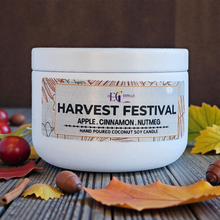 Load image into Gallery viewer, Harvest Festival candle with a label on a wooden surface with autumn leaves and fruits.
Apple Cinnamon nutmeg