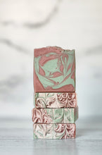 Load image into Gallery viewer, Stack of pink and green marbled soap bars on a light background. Indulge in our  handmade artisan soap bar that transforms your daily routine into a luxurious escape.