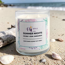 Load image into Gallery viewer, Candle labeled 'Summer Nights' on a sandy beach with ocean in the background