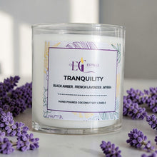 Load image into Gallery viewer, Candle labeled 'Tranquility' with lavender flowers around it. Black amber French lavender and myrrh