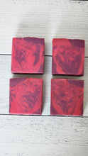 Load image into Gallery viewer, Four red and purple marbled soap bars on a light wooden surface. Indulge in our  handmade artisan soap bar that transforms your daily routine into a luxurious escape.