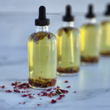 Load image into Gallery viewer, Herbal infused hair &amp; body oil in a glass dropper bottle